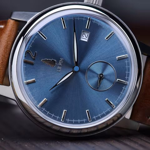 Angled view of the blue dial with the date window at three o'clock.